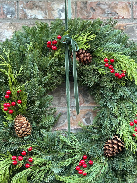 Close-up of evergreen needles, pinecones, and berries
Fresh Christmas wreath packaged for delivery from Oregon